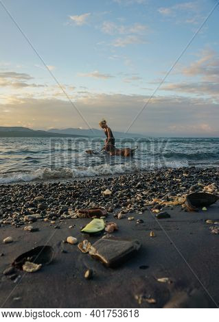 Banyuwangi, Indonesia - May 14, 2020 : A Woman Playing With The Dogs At Watudodol Beach Banyuwangi I