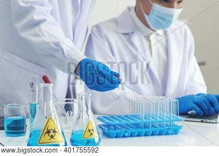 Two Asian Scientist Team Reserch Chemistry Science Tube Experiment Biotech Antibody Sample In Labora