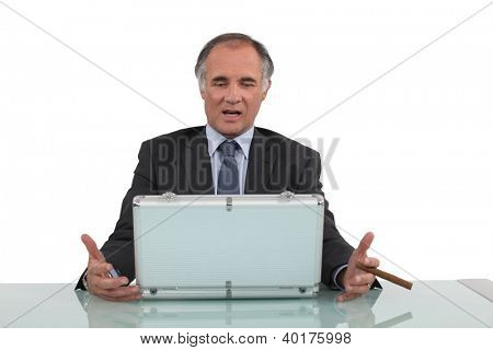 Senior businessman sat with cigar and metal briefcase