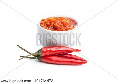 Red hot chili paste in bowl and chili peppers  isolated on white background.