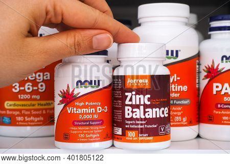 Tambov, Russian Federation - Ocrober 28, 2020 Person Hand Taking Bottle Of Vitamin D3 By Now And Bot