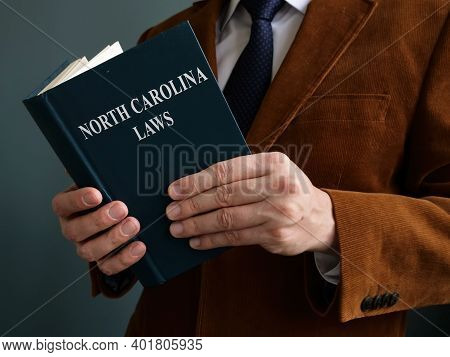 Man Reads North Carolina Law And Regulations.