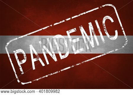 The Stamp Pandemic On The Background Of The Flag Of Latvia. Quarantine During The Covid-19 Coronavir