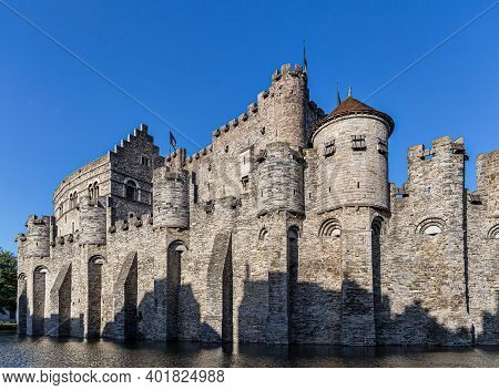Castle Of Ghent (gand) Mirroring In The Water (belgium)
