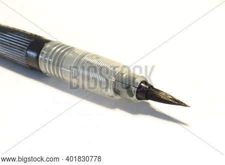 Close-up Of Brush Pen Soft Tip Calligraphy Black Ink Isolated On White Background. Brush Pen For Cal