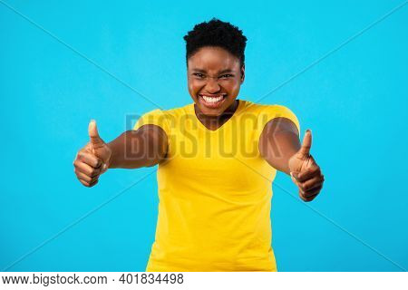 I Like It. Happy Plus-size Black Woman Gesturing Thumbs Up With Both Hands Approving Something Posin