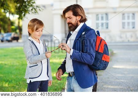 Cute Boy And Father Walking To School. Bearded Man With Son Wearing Fashion Suits Outdoors. Father T