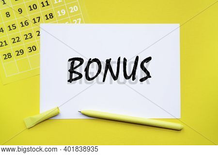 Bonus. Abstract Calendar Yellow Collour On A Yellow Background , Business Concept Written On Notepad