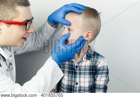 An Ophthalmologist Examines A Boy Who Complains Of Burning And Pain In His Eyes. Eye Fatigue From A