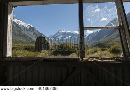 Window View In Old Trampers Hut In Mountains, On The Hookers Track, Mount Cook In New Zealand's Sout
