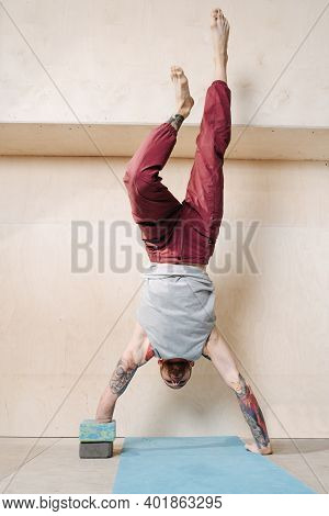 Young Disabled Armless Man Doing Handstand With Wall Assist