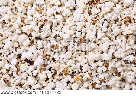 A Background Filled With Popped Popcorn Kernels.