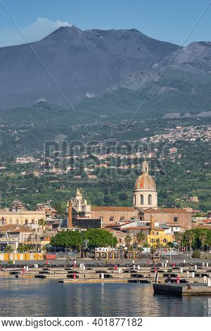 The marina of Riposto town in the morning with Etna volcano at background in Sicily, Italy.