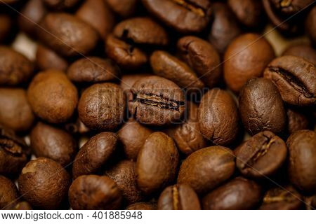 Coffee Beans Background. Fried Coffee On Grunge Wooden Background.