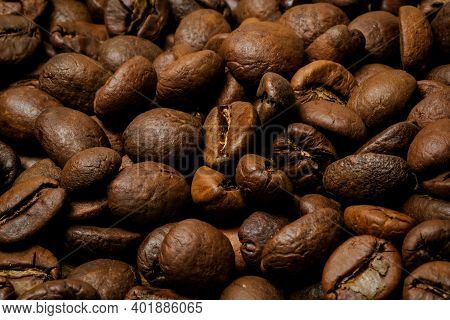 Coffee Beans Background. Fried Coffee On Grunge Wooden Background.