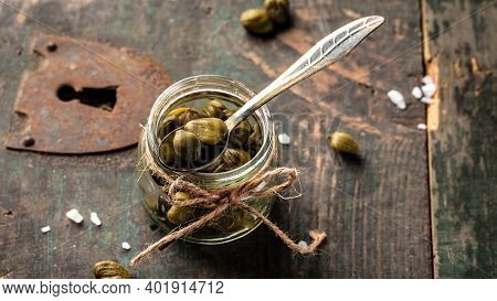 Pickled Capers On A Dark Wooden Background. Edible Flower Buds Of Capparis Spinosa, Caper Bush Or Fl