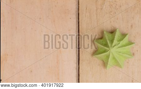 Green, Sweet, Crispy Meringue On A Wooden Background.
