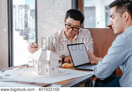 Businessman And Architech Meeting For Planing And Checking House Design And House Model And Secretar