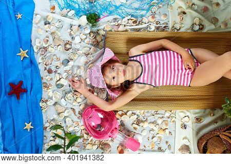 The Girls Is Lying On A Fictional Beach Near The Sea Or Ocean, Sunbathes.