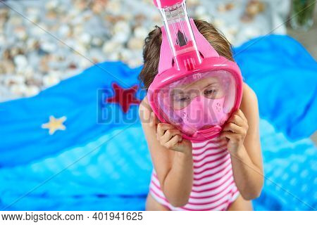 Little Girl Wearing Snorkeling Mask Imitates Swimming In Fictional Beach