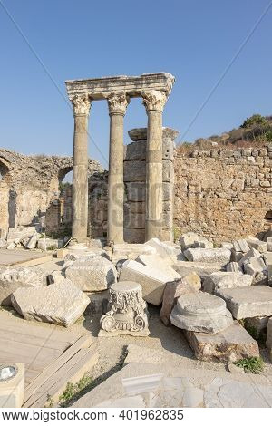 Stone Columns And Walls In Ephesus Ancient City. And There Is A Restoration On The Ground
