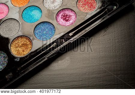 Colorful Makeup Palette On Black Background. Palette Of Colorful Eye Shadows, Close-up.