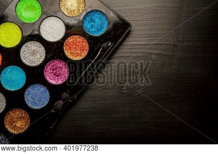 Colorful Makeup Palette On Black Background. Palette Of Colorful Eye Shadows, Close-up.