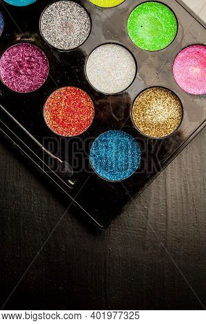 Colorful Makeup Palette On Black Background. Palette Of Colorful Eye Shadows, Close-up.