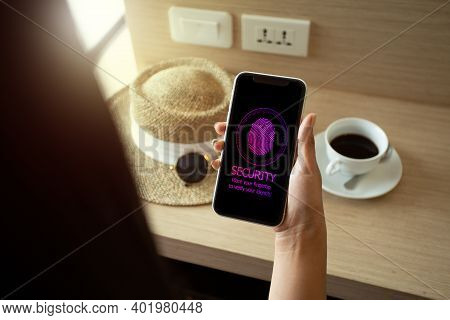 People On Holiday Using Smartphone To Sign A Password By Fingertip. Mobile Security Concept.