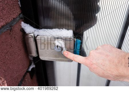 Man Hand Opening A Frozen Lock .frozen Door Lock On The Street