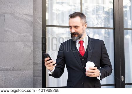 Selective Focus At Face. Adult Caucasian Business Man With Beard, Dress In Formal Suit Standing In C