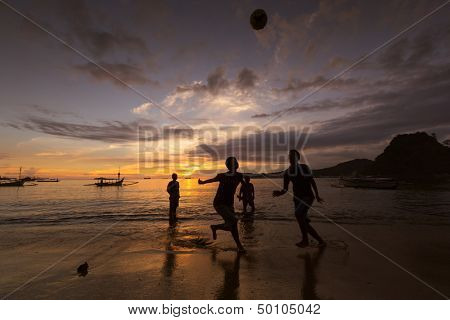 SUMATERA - AUGUST 23: Kids play soccer on the beach during sunset on August 23, 2013 in Padang, West Sumatera, Indonesia. Soccer is the most popular sports in South East Asia and the world.
