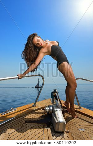 Young sexy woman on her private yacht