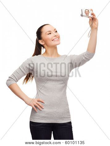 happiness, technology people concept - smiling asian woman taking photo with digital camera