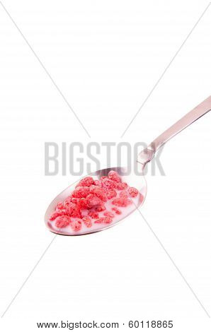 Pink cereal with milk in a spoon