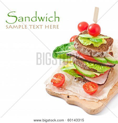 Sandwich with ham and fresh vegetables on white background