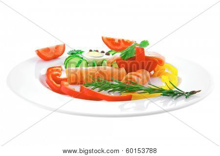 smoked salmon slices with vegetabls over white plate