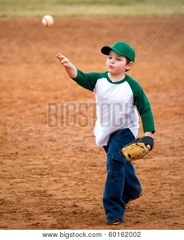 Boy throws baseball during practice