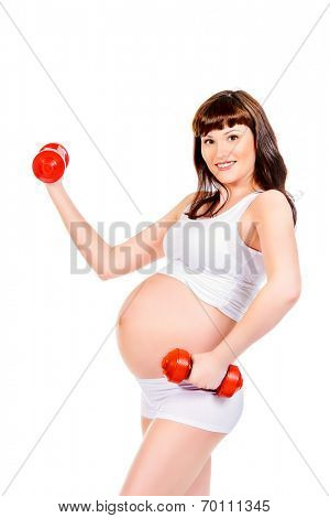 Beautiful pregnant woman doing exercise with dumbbells. Healthcare. Isolated over white.