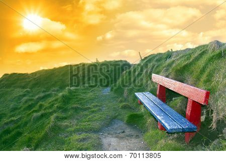 Bench On A Cliff Edge At Sunset