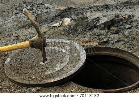 Pick Axe in a Man Hole Cover