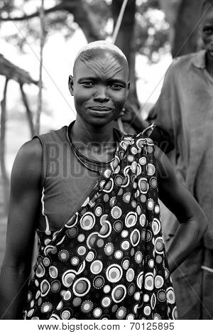 MANGALLA, SOUTH SUDAN-JUNE 22 2012: Unidentified South Sudanese woman with prominent head scarification near the village of Mangalla, South Sudan