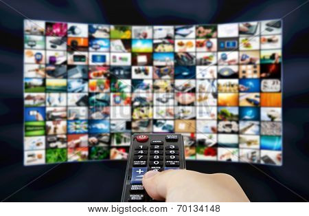 Big Lcd Panel With Television Stream Images And Remonte Control In Hand