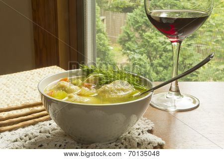 Delicious Matzoh ball soup with crackers wine and dill