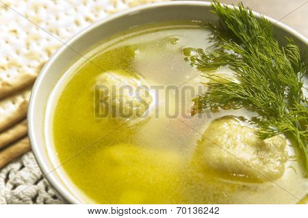 Delicious Matzoh ball soup with crackers wine and dill