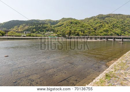 From a distance and crossing the river on Togetsukyo Bridge of Arashiyama