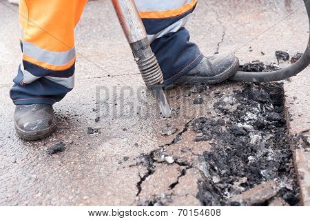 Road Worker Breaking Street Asphalt With Jackhammer