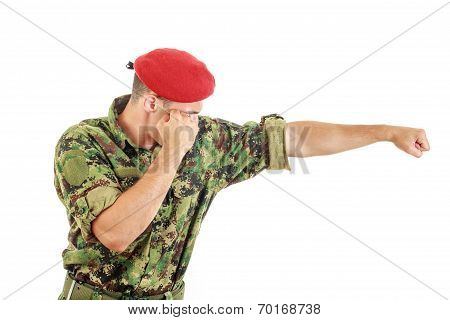 Soldier In Military Uniform And Cap Hitting With Fist