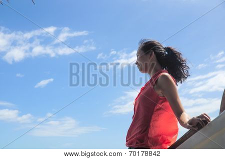 happy young girl leans on wooden boat