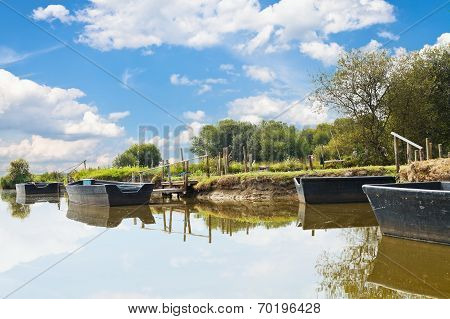 Wooden Boats Near Gangways On Lake, France